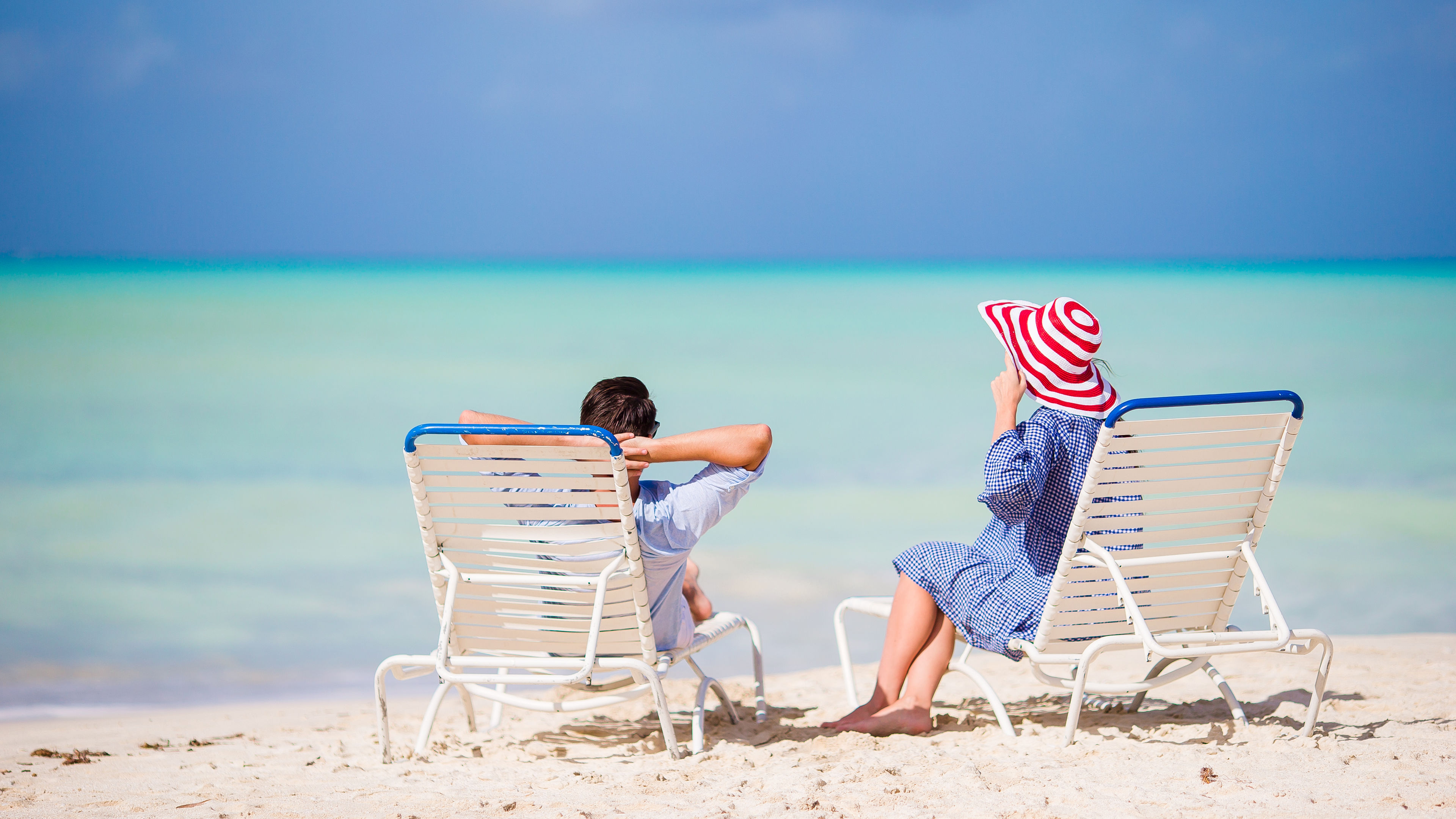 Young family on white beach during summer vacation